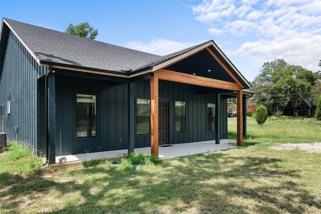 5253 Bill Cody Cir, Log Cabin, TX 75148 - rear view of house with board and batten siding, a yard, and a shingled roof