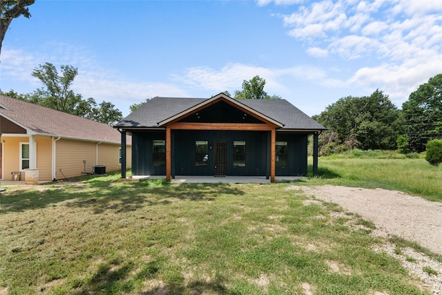 view of front of home featuring central AC unit and a front lawn