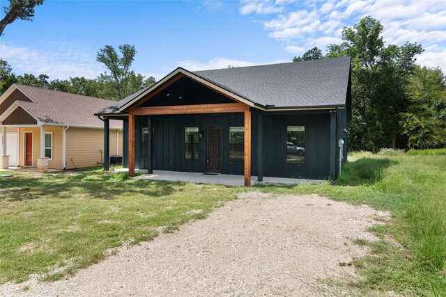 5253 Bill Cody Cir, Log Cabin, TX 75148 - view of front of home with board and batten siding and a front yard