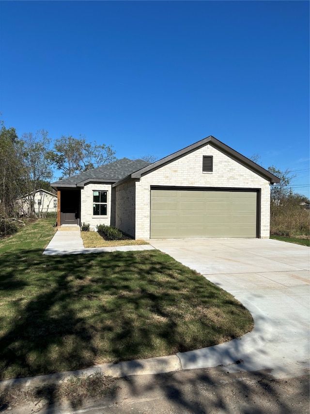 view of front of property with a garage and a front yard