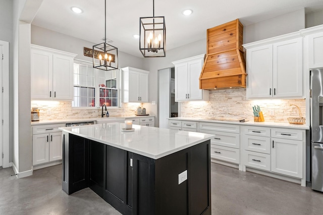 kitchen featuring a kitchen island, premium range hood, and white cabinets