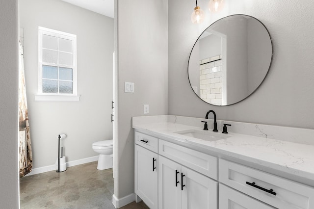 bathroom featuring vanity, toilet, and concrete floors