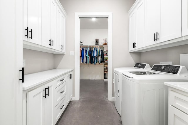 washroom with separate washer and dryer and cabinets