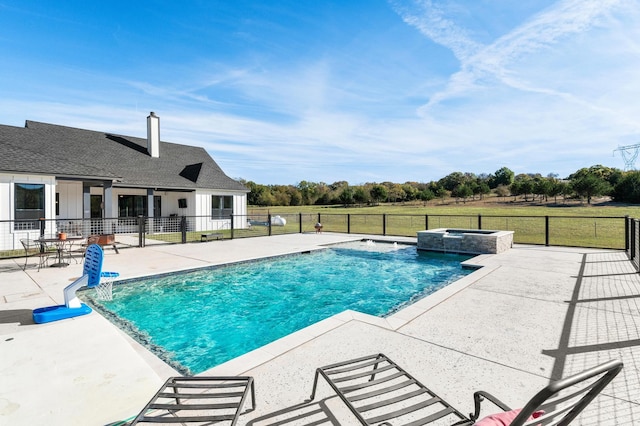 view of pool featuring a patio and an in ground hot tub