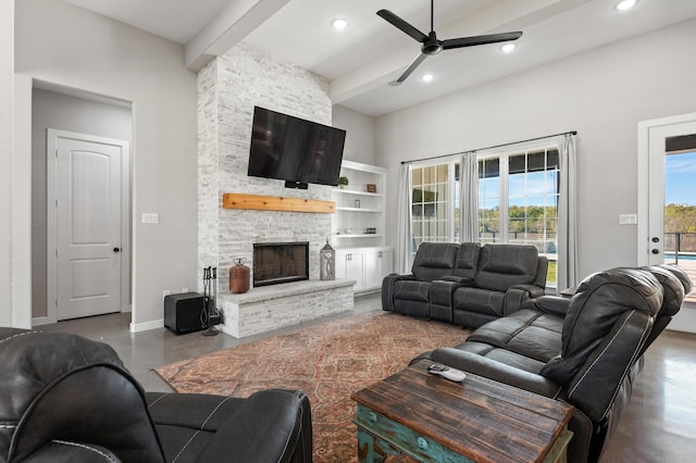 living room with a fireplace, ceiling fan, and beam ceiling