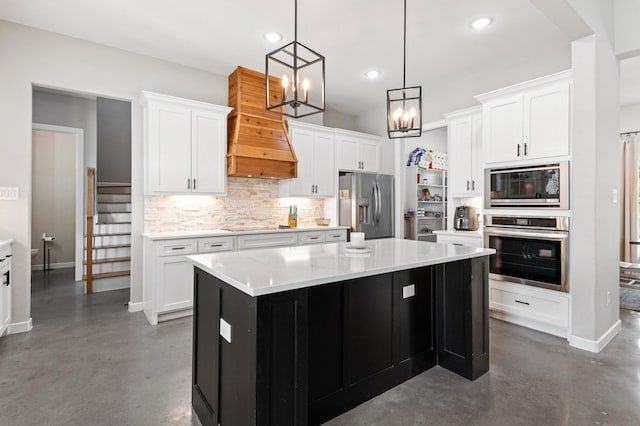 kitchen featuring white cabinets, stainless steel appliances, and a center island