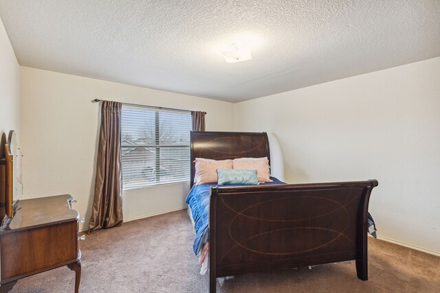 carpeted bedroom featuring a textured ceiling