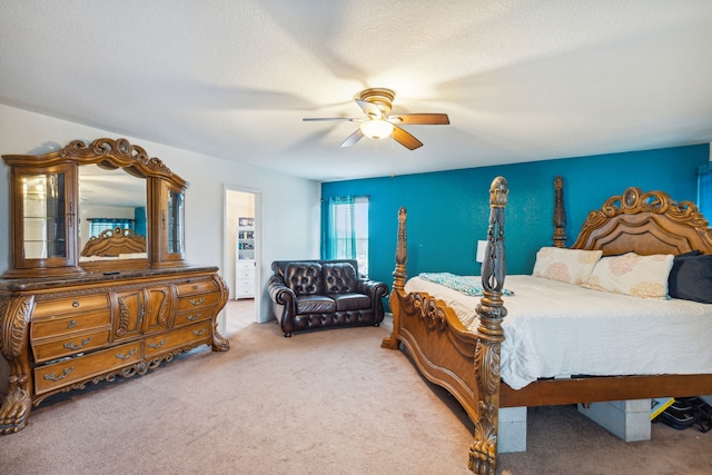 bedroom featuring a textured ceiling, ceiling fan, and carpet floors