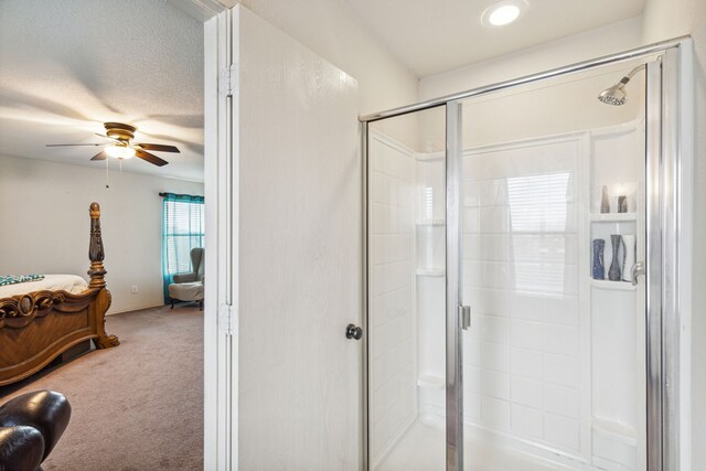 bathroom featuring walk in shower, a textured ceiling, and ceiling fan