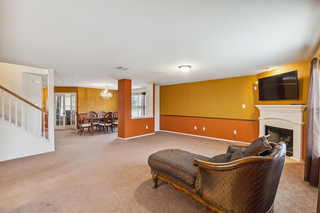 living room featuring carpet flooring and a notable chandelier