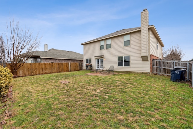 back of house featuring a lawn and a patio