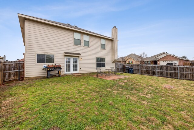 rear view of house with a yard and a patio