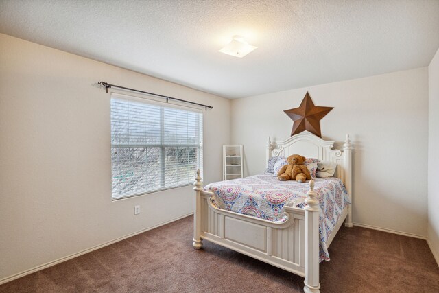 carpeted bedroom with a textured ceiling