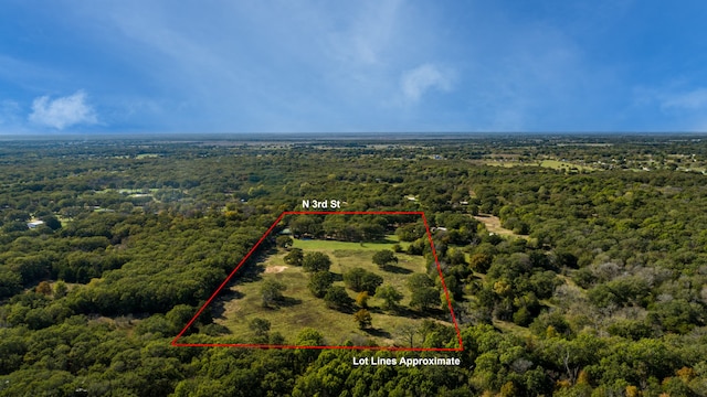 birds eye view of property featuring a forest view