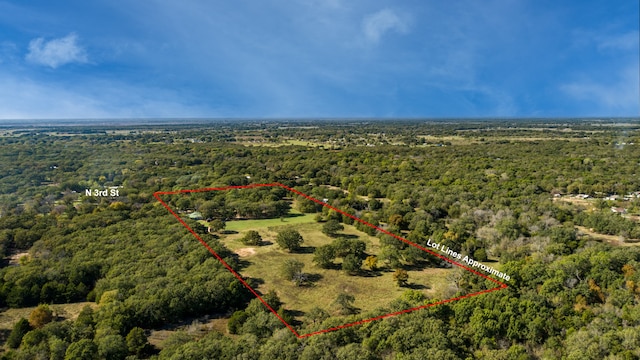 birds eye view of property with a view of trees