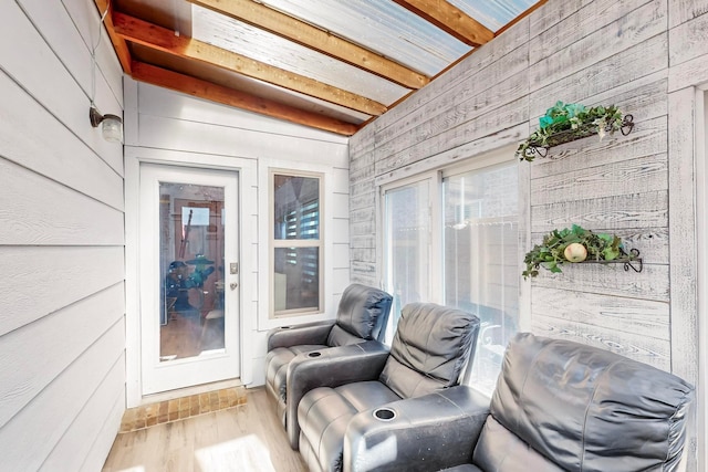 sunroom / solarium featuring beam ceiling