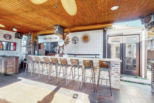 view of patio with ceiling fan and an outdoor bar