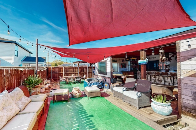 view of patio featuring an outdoor hangout area and a bar