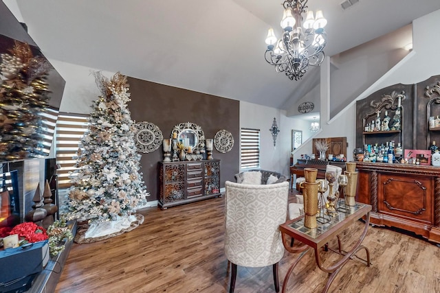 dining room featuring hardwood / wood-style flooring, high vaulted ceiling, and a notable chandelier