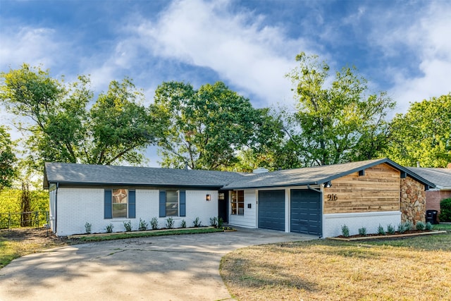 ranch-style house featuring a garage and a front yard