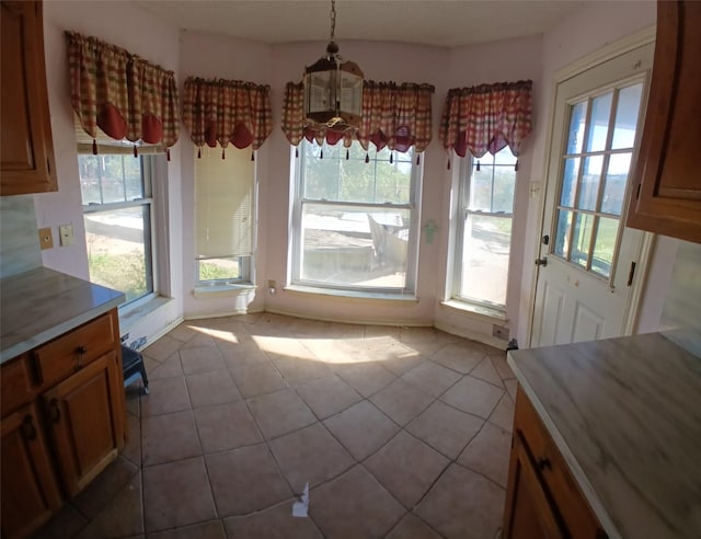 unfurnished dining area featuring light tile patterned floors