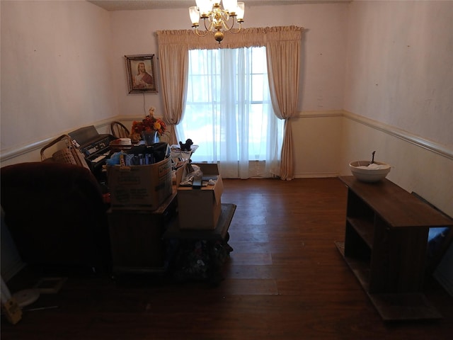 living room with dark wood-type flooring and a chandelier