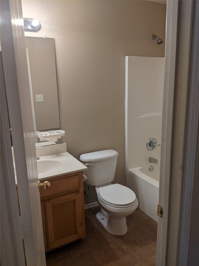 full bathroom with tile patterned flooring, washtub / shower combination, toilet, and vanity