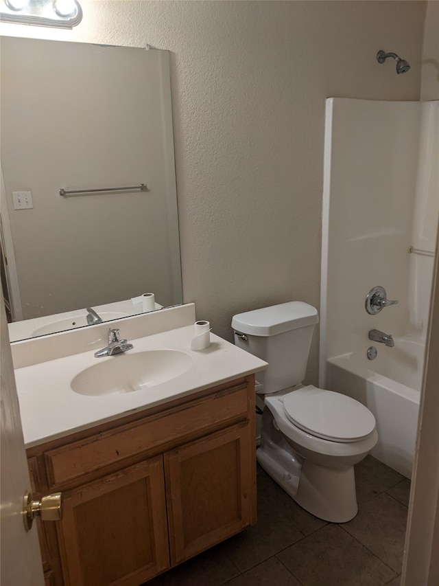 full bathroom featuring vanity, tile patterned flooring, shower / washtub combination, and toilet