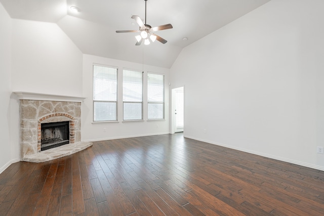 unfurnished living room with a fireplace, vaulted ceiling, ceiling fan, and dark wood-type flooring