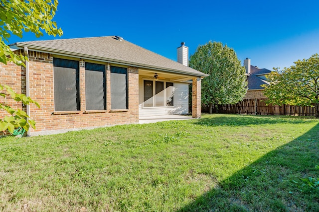 rear view of house with a lawn