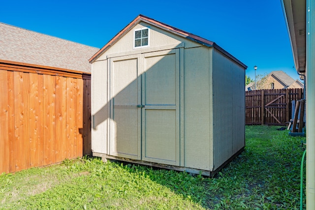 view of outbuilding with a lawn