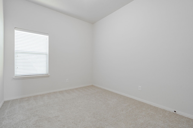 unfurnished room featuring light carpet