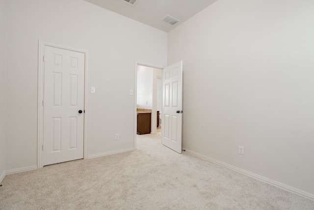 unfurnished bedroom featuring light carpet