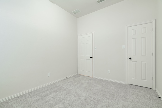 empty room featuring light carpet