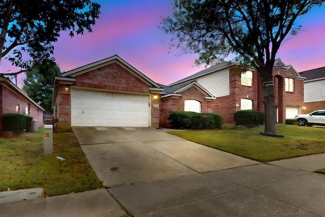 single story home with a garage and a lawn