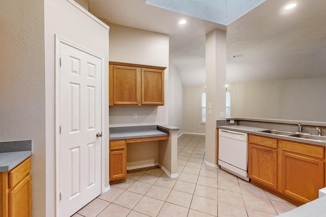 kitchen with sink, white dishwasher, and light tile patterned floors