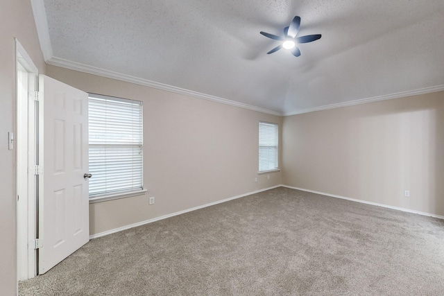 carpeted empty room featuring a textured ceiling, ceiling fan, and ornamental molding