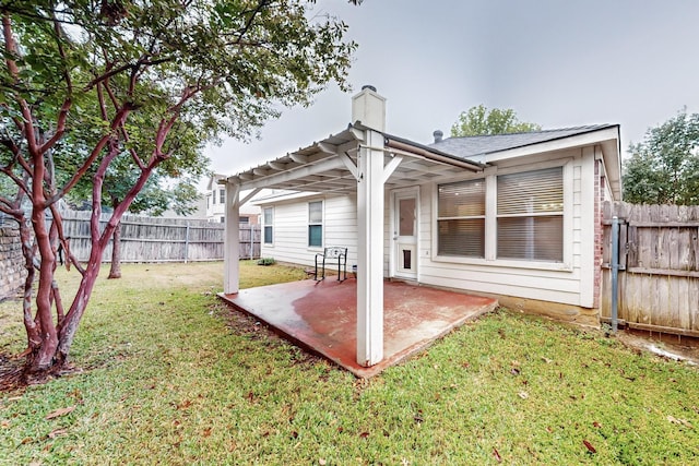 back of property featuring a lawn and a patio area