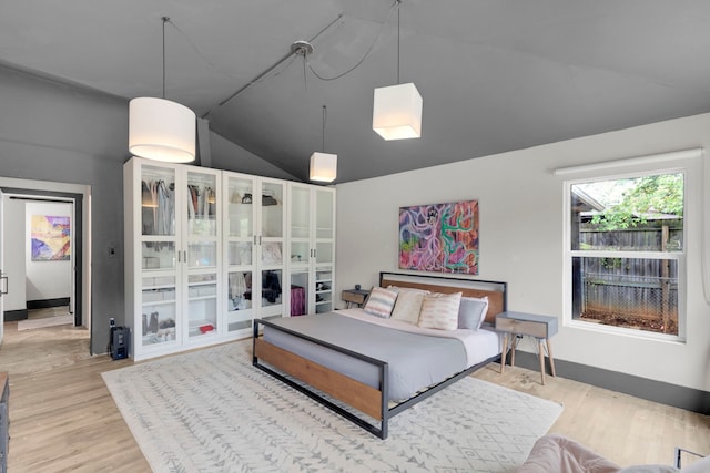 living room with light hardwood / wood-style floors and lofted ceiling