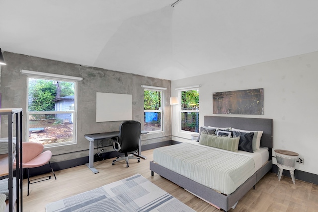 bedroom featuring wood-type flooring and vaulted ceiling