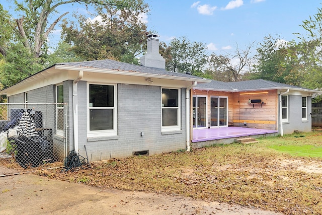 back of house featuring a lawn and a patio area