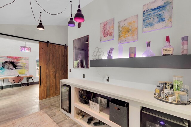 rec room with a chandelier, light wood-type flooring, electric panel, and vaulted ceiling