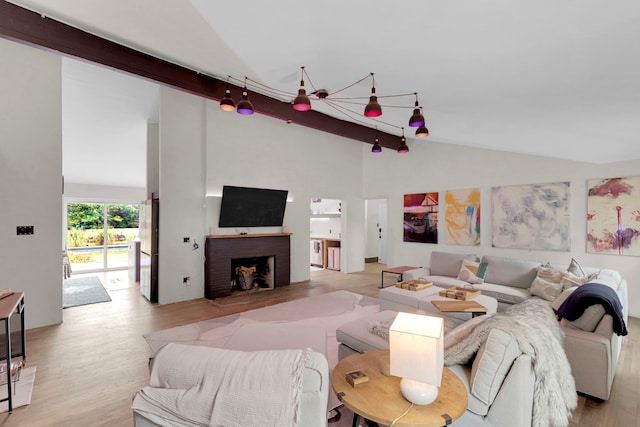 living room with light wood-type flooring, a fireplace, high vaulted ceiling, a notable chandelier, and beamed ceiling