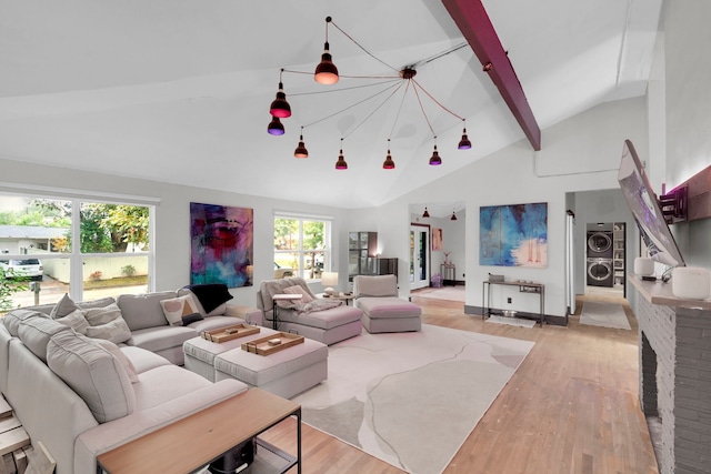 kitchen featuring hanging light fixtures, light wood-type flooring, a notable chandelier, a kitchen island, and a kitchen bar