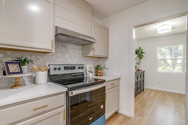 kitchen featuring ventilation hood, white cabinetry, backsplash, electric range, and light hardwood / wood-style flooring