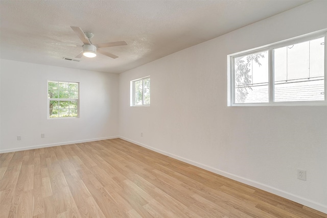 spare room featuring a textured ceiling, ceiling fan, and light hardwood / wood-style flooring