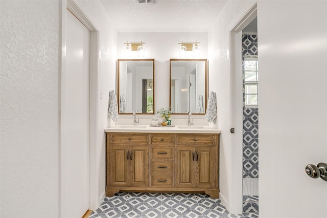 bathroom with vanity and a textured ceiling