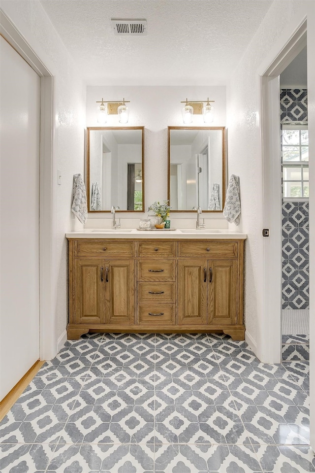 bathroom featuring vanity and a textured ceiling