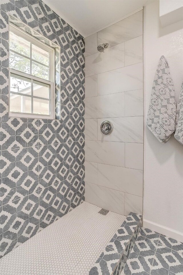 bathroom with a tile shower