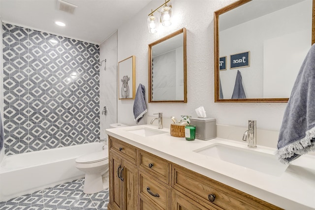 full bathroom featuring vanity, toilet, and tiled shower / bath combo